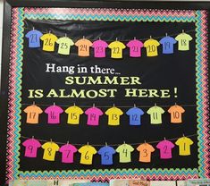 a bulletin board with clothes hanging from it's sides and the words hang in there summer is almost here