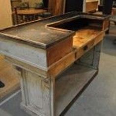 an old desk is being displayed in a store