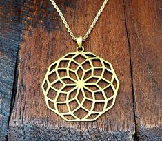 "Really cool gold sacred geometry pendant necklace! Made by hand with hypoallergenic jewelry brass. Measures 1.6\" wide. Comes with your choice of chain or cord. Awesome! *Satisfaction Guarantee* We're sure you'll love this jewelry piece. But if you are not satisfied with your purchase for any reason, then you may return it for a full refund. Any time. *About our shop* For several years we've traveled the globe searching for the finest in authentic vintage and antique art, jewelry, clothes and t Geometric Gold Nickel-free Jewelry, Adjustable Geometric Gold Jewelry, Gold Geometric Nickel-free Jewelry, Nickel-free Geometric Gold Jewelry, Bohemian Geometric Gold Jewelry, Handmade Geometric Gold Jewelry, Gold Geometric Brass Jewelry, Geometric Gold Jewelry Gift, Cadmium-free Brass Pendant Necklace