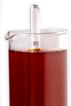 a red liquid in a glass container with a pipe sticking out of the top, on a white background