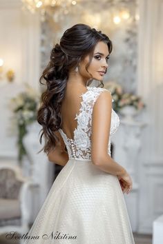 a woman in a wedding dress looking back