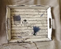 a white tray with blue flowers and writing on the side is sitting on a bed