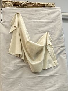 a white piece of cloth hanging on a wall