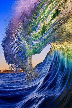 an ocean wave with the colors of rainbow and blue