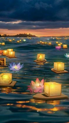 many floating candles in the water with lights on them and flowers at the end of each candle