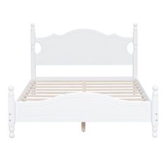 a white bed frame with wooden posts and headboard on an isolated white background photo