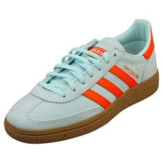 Step up your streetwear game with these adidas Handball Spezial trainers in a vibrant Aqua Orange. Crafted from a sleek combination of suede and synthetic materials, they offer both style and durability. The textile lining and insole ensure all-day comfort, while the classic lace-up fastening provides a secure fit. Complete with a rubber sole for lasting traction, these eye-catching trainers are perfect for adding a bold touch to any outfit. Style: HANDBALL SPEZIAL Outer: Suede & Synthetic Linin Fashion Trainers, Adidas Handball Spezial, Adidas Handball, Orange Sneakers, Trainers Fashion, Synthetic Materials, Outfit Style, Low Cost, Step Up