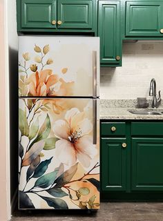 the refrigerator is painted with flowers and leaves on it's side, along with green cabinets