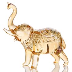 an elephant figurine is shown on a white background