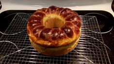 a bundt cake sitting on top of a cooling rack next to an oven door