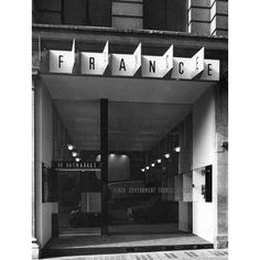 black and white photograph of the entrance to a french department store in paris, france