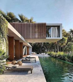 an outdoor swimming pool next to a house