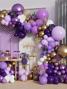 a purple and gold birthday party with balloons