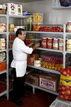 a man standing in front of a shelf filled with food