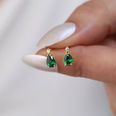 Elevate your jewelry collection with our exquisite 14K Solid Gold Solitaire Diamond Drop Stud Earring, beautifully adorned with a vibrant emerald, the birthstone of May. Each earring features a meticulously set genuine diamond on top, leading the eye to a stunning solitaire emerald that dangles with every movement, capturing light and admiration alike. This piece is not just an accessory; it's an elegant statement, perfect for celebrating a May birthday or marking a special occasion. Crafted fro Emerald Sets Jewellery, Emerald Pear-shaped Fine Jewelry Earrings, Yellow Gold Pear-shaped Earrings As Gift, Yellow Gold Pear-shaped Earrings For Gift, Pear-shaped Yellow Gold Earrings As Gift, Pear-shaped Yellow Gold Earrings For Gifts, Classic Teardrop Earrings For May Birthstone, Classic Teardrop May Birthstone Earrings, Green Pear-shaped Earrings For Anniversary