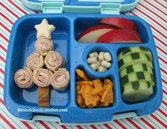 a blue lunch box filled with food on top of a table