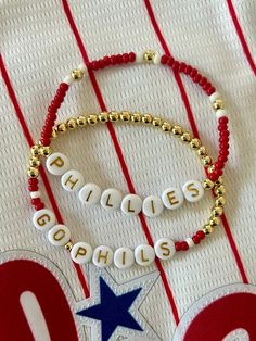 - Calling all Phillies fans! Personalize your custom Philadelphia Phillies bracelet for game day. Choose from classic red seed bead with 18k gold accents, full gold beaded beaded with red accents or get a set. Gold filled beads are much more tarnish resistant and long lasting, opposed the the more commonly seen gold plated. These bracelets layer well with others so add this to your stack for your next tailgate! Beaded on high quality stretch cord and secured. - Listing is for (1) bracelet or set of (2). Set includes (1) gold beaded bracelet with red accent and (1) seed bead bracelet.  -  4mm 18k gold filled beads       3mm glass seed beads     acrylic letter beads      -  Enter your own customization in personalization box. Feel free to message me with any questions. - Each purchase is sen Phillies Bracelet, Acrylic Letters, Gold Bead Bracelets, Letter Beads, Layered Bracelets, Seed Bead Bracelets, Philadelphia Phillies, Red Accents, 2 Set