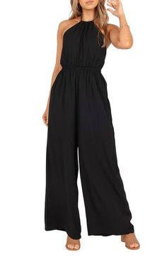 Fall for the sophisticated silhouette of this breezy day-to-night jumpsuit designed in a halter silhouette with flowy wide legs. Adjustable back tie closure; ties at neck Halter neck Lined 100% polyester Hand wash, line dry Imported Spring Halter Neck Jumpsuit Or Romper, Spring Halter Neck Jumpsuit, Wide Leg Jumpsuit For Beach, Summer Evening Halter Neck Jumpsuits And Rompers, Summer Evening Jumpsuits And Rompers With Halter Neck, Chic Wide-leg Beach Jumpsuits And Rompers, Spring Strapless Halter Neck Jumpsuit, Chic Wide Leg Beach Jumpsuits And Rompers, Chic Wide Leg Jumpsuits And Rompers For Beach