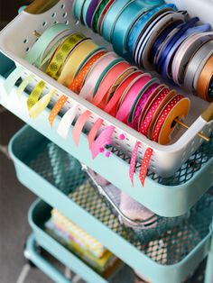 a rack filled with lots of different types of ribbons and spools on it