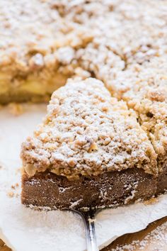 a close up of a piece of cake on a plate with a fork in it