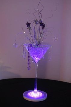 a purple light up martini glass sitting on top of a table