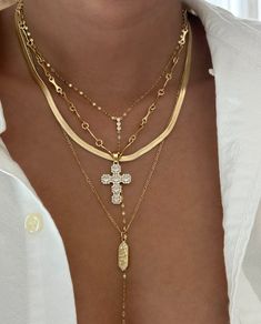 This minimalist yet elegant necklace features a gold-filled cross pendant encrusted with cubic zirconia for a stunning sparkle. Paired with a unique gold-filled chain, this piece offers a modern take on a classic design, perfect for layering or wearing on its own as a statement. 14k Gold Filled Chain Cross Pendant with CZ stones Charm size: 26.4mm x 18.3mm Chain length: 16" with 2" extender Lobster clasp closure Hypoallergenic Water resistant & tarnish free Nickel & lead free Cross Pendants Woman, Cross Necklace Stack, Cross Chain Aesthetic, Beaded Cross Necklace, Chains Aesthetic, Gold Cross Necklace, Beaded Cross, Swarovski Crystal Necklace, Cross Chain