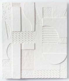 an abstract white paper sculpture with different shapes and sizes