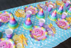 there is a table set up with cups and plates for children's birthdays