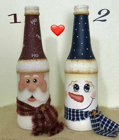 two wine bottles with santa and snowman faces painted on them, one has a scarf around his neck