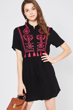 Be a wildflower in a field of roses in this bohemian beauty. This fun & flirty dress features a classic collar, button down front, short sleeves, beautiful embroidery and tassel detailing, is lined from the waist down, light weight and has an a-line mini silhouette. Small Bust 36" Length 33" Medium Bust 38" Length 33" Large Bust 40" Length 33" 65% Cotton 35% Polyester Imported Hand Wash Cold Model is 5'8" and wearing size Small Summer Folk Dress With Short Sleeves, Spring Festival Embroidered Short Sleeve Dress, Spring Festival Short Sleeve Embroidered Dress, Folk Style Embroidered Short Sleeve Summer Dress, Folk Style Embroidered Short Sleeve Dress For Summer, Folk Style Embroidered Short Sleeve Dress For Spring, Summer Folk Style Embroidered Dress With Short Sleeves, Summer Folk Dress With Tassels, Folk Style Summer Dresses With Tassels