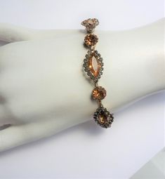 This is an estate vintage amber and rhinestone bracelet. It is 7 inches long and 14.13 grams in weight. Formal Crystal Bracelet With Stones, Vintage Amber Bangle Jewelry, Antique Jeweled Bracelets For Party, Brown Bangle Jewelry For Formal Occasions, Brown Bangle For Formal Occasions, Orange Bracelet For Formal Occasions, Formal Orange Bracelet Jewelry, Formal Orange Bracelet, Vintage Amber Jewelry For Party