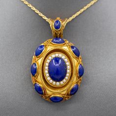 Exquisite Antique Etruscan Revival Lapis and Pearl Locket Pendant in 18k Yellow Gold The contrast in color of this locket is exquisite, and it is impeccably made.  The locket features cabochons of natural lapis lazuli, with the center cab surrounded in a frame of seed pearls.  This is a picture locket with a window on the back which can be opened and a photo inserted.  It features a really wide bail so that the piece can be worn over large chains or silk ribbon.  The locket is crafted in 18k (x Lapis And Pearl, Pearl Locket, Victorian Locket, Picture Locket, Antique Jewelry Necklace, Seed Pearl, Locket Necklace, Silk Ribbon, X Ray