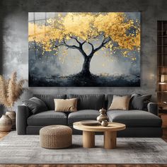 a living room with grey couches and a large painting on the wall above it