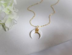 "NATURAL CRESCENT MOON NECKLACE * BOHO CHIC SMALL TUSK NECKLACE This small tusk necklace is made of Mother of Pearl. It's simple and elegant. It's light and easy to wear. Perfect for layering or wearing on its own. IT'S IN THE DETAILS * This listing is for the genuine mother of pearl necklace * 14K Gold Filled Chain - Shown at 17\" in photo #2 * Mother of Pearl Tusk in Cream or White - 20mm * To add the chain choker in photo #1, click here: https://www.etsy.com/listing/787283259 WHY YOU'LL LOVE Gold Crescent Moon Necklace, Tusk Necklace, Crescent Moon Necklace Gold, Gold Crescent Moon, Celestial Gifts, Horn Necklace, Mother Of Pearl Necklace, Crescent Moon Necklace, Necklace Boho