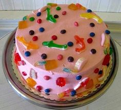 a pink cake with lots of colorful candies on it