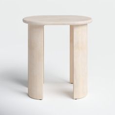 a small white table sitting on top of a white floor