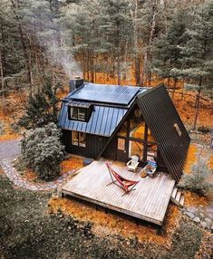 an aerial view of a small cabin in the woods