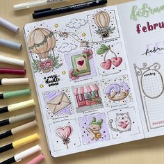 an open planner with lots of stickers and markers on it next to some pens