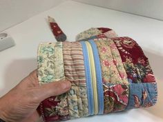 a hand is holding several pieces of fabric