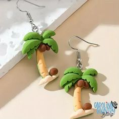 Embrace the tropics and take a risk with our Coconut Multi earrings! Featuring vibrant palm trees, these earrings will add a touch of adventure to any outfit. Show off your bold style with this must-have accessory. Measures 1 1/4" Sold as one pair of earrings. Fun Drop Earrings For Beach, Novelty Green Summer Jewelry, Green Novelty Jewelry For Summer, Green Novelty Summer Jewelry, Trendy Dangle Earrings For Vacation, Beach Fun Drop Earrings Jewelry, Tropical Green Jewelry For Summer, Summer Tropical Green Jewelry, Tropical Green Summer Jewelry