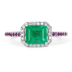 Featured is a 3.25-carat elegant Colombian emerald, diamond, and pink sapphire engagement/cocktail ring. The center stone is a very well saturated green emerald with perfect weight: 2.95-carats. The center stone has beautiful eye clarity and is an AAA+ quality gem. Embellishing the emerald are numerous, brilliant round, diamonds in a sleek rose gold pave setting. Pink sapphires and white diamonds are also pave set on the shank and highlight the ring beautifully. Mil grain detail is seen througho Emerald-cut Multi-stone Diamond Emerald Ring, Emerald Cut Emerald Ring With Multi-stone Diamond, Emerald Cut Multi-stone Emerald Jewelry, Emerald Multi-stone Round Cut Ring, Multi-stone Round Cut Emerald Ring, Round Cut Multi-stone Emerald Ring, Diamond Multi-stone Emerald Ring For May Birthstone, Multi-stone Emerald Diamond Ring For May Birthstone, Multi-stone Emerald Cut Emerald Ring For May Birthstone