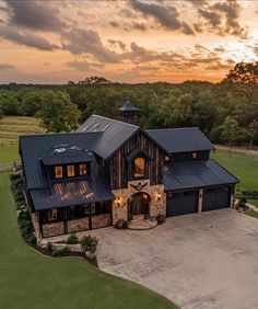 this is an aerial view of a large home in the countryside at sunset or dawn