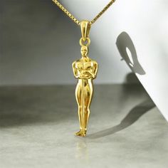 This handcrafted 14K gold Oscar pendant is a perfect example of elegance and style. Weighing approximately 3.55 grams, the pendant is paired with a refined 14K gold chain that weighs 1.95 grams. Its unique design and high-quality craftsmanship make it ideal for both special occasions and everyday wear. The pendant comes in a luxurious gift box, making it a perfect choice for gifting a loved one or treating yourself. Formal Engraved Gold-plated Necklaces, Formal Gold Plated Engraved Necklaces, Formal Gold Plated Engraved Necklace, Formal 14k Stamped Pendant Necklace, Classic Necklaces With Shiny Finish For Anniversary, Classic Necklace With Shiny Finish For Anniversary, Elegant 14k Stamped Pendant Necklace, Classic Shiny Finish Necklace For Anniversary, Classic Wedding Necklaces With Charms