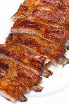 sliced meat sitting on top of a white plate