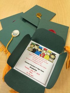 a green graduation cap with a yellow tassel on it and a card attached to it