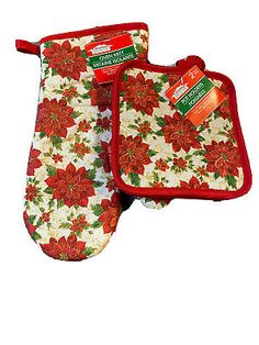 two oven mitts with red poinsettis and green leaves on white background