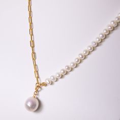 Half square gold chain linked with half white round pearl necklace designed to present a mixed style of rock and feminine feeling. The big round pearl pendant is also eye-catching. It's a go-to piece for a casual everyday look. Pearl Type: Freshwater Pearls Pearl Quality: [Shape]: Round Pearl [Pearl Size]: 12-14mm [Blemish]: Minimal [Luster]: High Necklace Length: 40+5cm Chain Material: 18k Gold-Filled Sterling Silver Note: Every pearl is unique. Items may slightly vary from the pictures. Modern White Pearl Chain Necklace, Modern White Pearl Necklace, White Pearl Necklace With Gold Chain, White Chain Necklace With Round Pearl Pendant, White Chain Necklace With Pearl Pendant, White Pearl Pendant Chain Necklace, Modern White Necklace With Pearl Charm, Modern White Necklaces With Pearl Charm, White Pearl Necklace With Adjustable Chain And Round Pendant