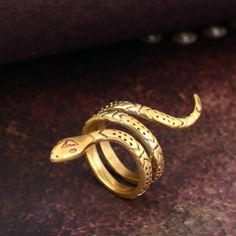 Minimalist snake ring, Gold snake ring, Brass snake ring, Engraved snake ring, Spiral ring, Gold wrap ring, Serpent ring, Wild Animal ring Metal:- Brass ✦ Our rings are made of high-quality Brass metal and are carefully crafted by hand in our family workshop. The brass metal will develop a nice antique color over time. So, I suggest cleaning it once in a while for getting back to the shiny original color. You can use natural ingredients like lemon or vinegar with water to clean it. Also, apply a thin coat of transparent nail paint/nail enamel on the ring's inner side to save it from being tarnished. ❥ You may request to return the products, 15 days after you received the items (Delivery Day). The buyer is responsible for the shipping costs for the return. (We may have slower production at Adjustable Metal Snake Ring, Snake-shaped Metal Rings As A Gift, Snake Shape Metal Ring As Gift, Metal Snake Ring With Open Design For Gift, Metal Open Snake Ring For Gift, Adjustable Symbolic Snake Ring, Adjustable Spiral Snake Ring As Gift, Handmade Snake Shaped Ring As Gift, Handmade Metal Open Snake Ring