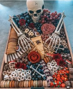 a wooden tray filled with lots of different types of food and bones on top of it