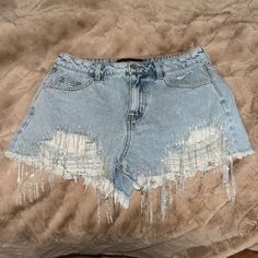 Denim Shorts With Silver Sparkly Fringe At Front Distressed Party Cutoff Denim Shorts, Short Denim Jeans For Party, Denim Party Shorts, Short Denim Party Jeans, Short Party Jeans, Casual Denim Bottoms For Party, Casual Denim Party Bottoms, Mid-rise Denim Bottoms For Party, Blue Denim Shorts For Party